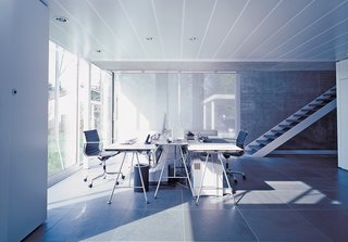 The office area, complete with Eames aluminum management chairs and desks from Atelier Alinea, can be completely sealed off from the rest of the house.