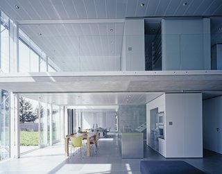 An electronically controlled louver shading system protects the glass façade of the kitchen, office, and upstairs open-plan bedroom from the sun.