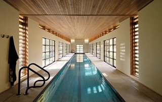 Competitive swimmer Sydne Didier commissioned Austin Design Inc. to create a 102-foot-long pool house in a freestanding structure behind her Amherst, Massachusetts, house.