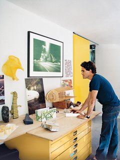 7 Incredible Home Offices of Designers and Architects - Photo 3 of 7 - A row of windows casts light into the office, where Bellemo keeps a model of the house. The office is separated from the garage by a bright yellow sliding door.