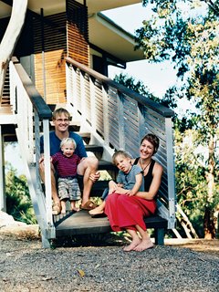 Stefan Dunlop and Adrienne Webb repose on their front entrance stairs with their sons Keanu and Kobe.