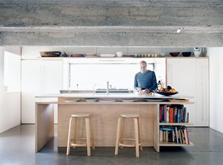 A pair of Aalto stools—in this case, the High Stool 64—are a prominent feature of this kitchen in Balmain Point, Australia, a suburb of Sydney.