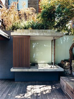 The glass and wood walls of the bathhouse, like other retractable panels on the house, <br><br>offer shade with a view.