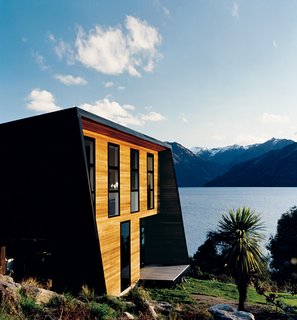 Nature Nurtured - Photo 2 of 11 - The sunny side of the home is clad in cedar weatherboards and features sleeping quarters on the upper level with living spaces below.