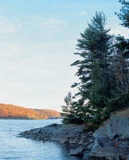 Barerock’s low-impact minimalist charm is due in part to its rugged location on secluded Drag Lake. The lack of road access ruled out the use of heavy equipment to construct the house, and just getting the materials to the site required major effort. (The topography had stymied previous generations of loggers who harvested the surrounding area, but left the Molenaars’ property untouched.) "The whole challenge of figuring it out was amazing," says Diane.<br><br>After an aborted attempt to airlift material to the property using a helicopter, the Molenaars settled on using a boat and their free-floating dock to haul supplies to shore.