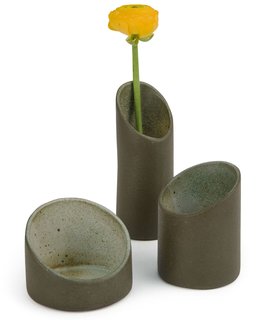 These cylindrical nesting vases are inspired by the shape of bamboo. Though made from ceramic, the surfaces have a roughness that evokes forests or jungles. They come as a set of three and can be stacked and used as a single vase, or separated and arranged as a trio. Made by hand in Brazil. 5 ½" h x 3 1/3" diam. $80.00