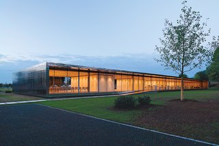 SWM Heilbronn is a one-story office building—mostly constructed using reinforced concrete—wrapped in a stainless steel fabric.