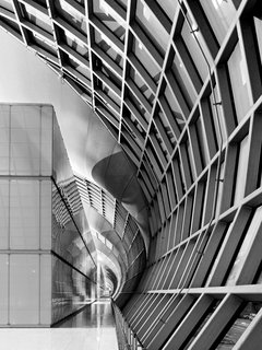 A concave surface inside one concourse of Suvarnabhumi International Airport is juxstaposed with a continuous vertical surface.
