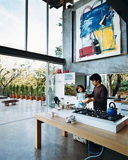 Welcome to the Jungle - Photo 8 of 8 - José Roberto, who says his family is always cooking something, prepares a snack with Jimena on the Ariston gas cooktop installed on the custom table.