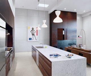 When Nilus De Matran renovated this San Francisco kitchen ten years ago, he chose materials that would not only compliment and unify the open space—dark walnut, terrazzo flooring, and Carrara marble—but also materials that would stand the test of time.