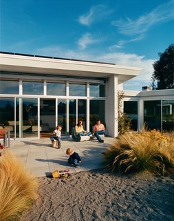 The Harris family rests easy on their new back patio abutting the Belvedere lagoon. The first order of business for this green remodel was to reconnect the house with its surroundings.
