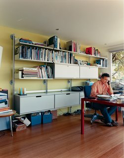 What was once a boat room now serves as a home office. The engineered bamboo floors are from Eco Timber. The modular shelving and storage systems are by Vitsoe.