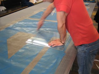 Touring Switzerland: Day 2 - Photo 1 of 2 - A bag designer at Freitag uses a template to take stock of the graphic possibilities of a used truck tarp.