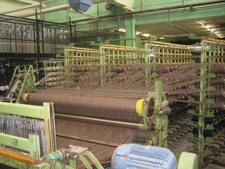 One of the massive weaving machines at Ruckstuhl, where up to 3600 spools of thread are needed for each rug.