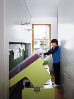 Storage-Smart Renovation in New York City - Photo 3 of 14 - All it takes is gentle downward pressure to lower the desk to the floor, bringing the kid-size mattress into position for bedtime.