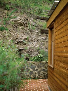 Compound Addition - Photo 10 of 12 - The steep canyon wall rises directly behind the house.