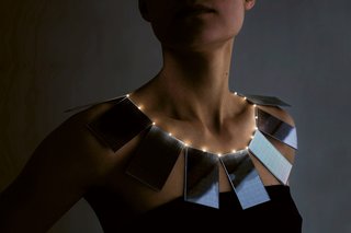 Lux necklace by Mae Yokoyama<br><br>Mae Yokoyama's necklace combines haute couture and high technology to highlight the benefits of solar energy. During the day, the solar panels create a bold collar necklace. At night, the energy accumulated during the daytime illuminates small lights to create the effect of a string of pearls, Yokoyama writes about her design.<br><br>Photo by Andreas Nyquist