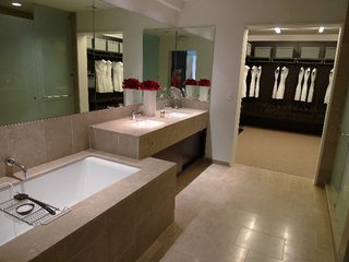 The bathrooms feature fossilized Brazilian limestone, Kohler fixtures, and Poliform closets.