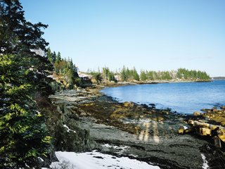 Views of the Penobscot Bay from the house’s small beach remain spectacular even with a blanket of February snow.