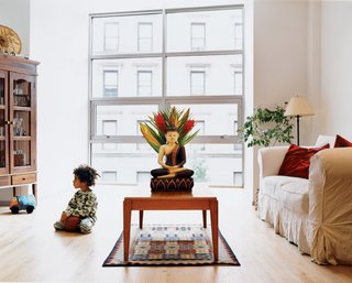 Harlem Renaissance - Photo 3 of 11 - In the living room, the floor slopes up to meet the glass within the bay window. Both gestures are designed to draw the family toward the light and views.