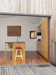 Pedigree Charted - Photo 2 of 10 - A painting by Aboriginal artist Yinarupa Gibson Nangala hangs in the kitchen, with a barstool from Danish designer Erik Buch in the foreground.