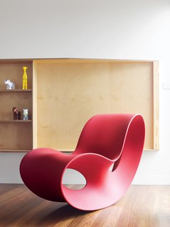 Pedigree Charted - Photo 6 of 10 - Ferguson’s prized Voido rocking chair is positioned by a living-room window that affords views of the small town and its beach. Designed in 2002 by Ron Arad for Magis, the Voido is blow-molded entirely from polyethylene.