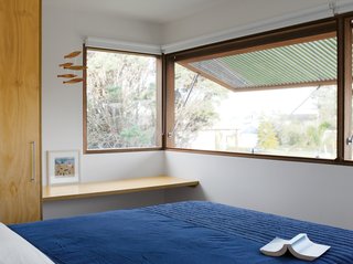 Pedigree Charted - Photo 7 of 10 - Nick’s father, Glenn Murcutt, insists on banks of sliding windows, louvers, and fly screens to allow for both natural ventilation and wintertime heat retention. Here Neeson and Murcutt opted for something simpler: large custom-made windows by Windoor that push out from below. Operated by a simple hydraulic system, these windows have spotted-gum slats, which allow for privacy. To keep out mosquitoes, the architects used a thin metallic screen from Phoenix Fly Screens to sit flush against the window. Held in place by magnets, it’s easily pulled away for storage in the wintertime.