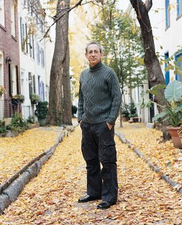 Ken Kalfus stands amidst the autumn leaves.