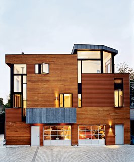 Ample windows cut into the north elevation of the Valentine House, behind which live the architects. The openings reveal lofty double-height spaces inside. The ground-floor garage often serves as a shop for architectural model-making.