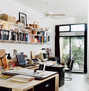 The ground-floor office is flooded with light from two sides.