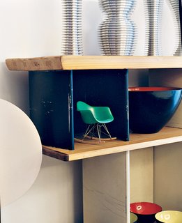 A miniature Eames rocker nestles in a Charlotte Perriand bookcase.