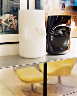 Murano glass vases by Jerszy Seymour rest atop a Maarten van Severen shelving unit in the sitting room.