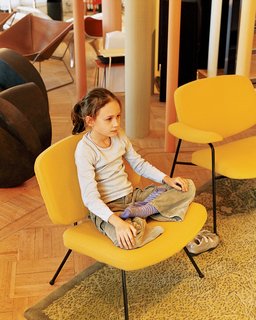 Clara strikes a yoga pose on a vintage Pierre Paulin chair for Artefort.
