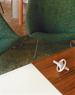 A ceramic Bouroullec vase sits atop a coffee table by Joseph-André Motte.