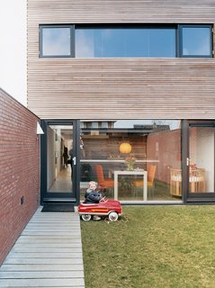 Because the Collette residence, although by no means small by Dutch standards, is a compact 2,050 square feet, the inside/outside relationship is important. Glass walls front and back bring the outdoors in. Two-year-old Jort takes full advantage of the great outdoors.