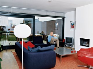 In the living room, Caspar educates his young son Roemer about the finer points of modern design. The red leather Gigi is van den Berg’s racy yet refined swivel armchair. Looking at this chair, it comes as no surprise that the designer drives a Porsche. "It’s from the late ’90s, but it’s already a classic," says Caspar. "I just love the versatility of this one—you can sit forwards or sideways in it." Van den Berg also designed the stainless-steel coffee table. The purple sofa was designed by Rodolfo Dordoni, and the Glo-Ball lamp is by Jasper Morrison.