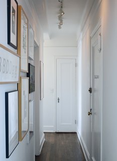 A narrow hallway, typical of prewar apartments, doubles as an art gallery lined with woodcut type studies by graphic artist Jack Stauffacher, type sketches by Erik Spiekermann, and photography by Catherine Opie and Catherine Ledner.