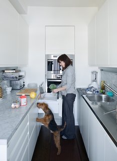 The kitchen is a miracle of efficiency, with Antonio Citterio’s Convivium system for Arclinea shoehorned into a tight galley layout. The built-in Miele oven has storage above, and the Sub-Zero drawers are far less bulky than a freestanding refrigerator. The Carrara marble countertop and backsplash were custom cut by Brooklyn’s Acme Marble Co.