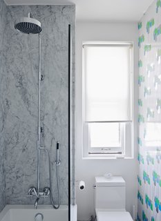 Brooklyn–based graphic designers Jeanette and Mike Abbink worked with Architecture + Construction to renovate their residence. In the bathroom, the gray Carrara walls are offset by bright tulip-patterned wallpaper, circa 1970, from Secondhand Rose in Tribeca. The toilet is a Philippe Starck "jet action" model from Duravit. Read the entire article here.
