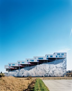 Completed in 2008, the Mountain Dwellings is the second of BIG’s three projects in Ørestad, a new neighborhood in Copenhagen where development is attracting many new inhabitants. The result does looks like a mountain—hence the building’s name and the inspiration for the mural of Mount Everest that adorns the 82-foot-high facade.