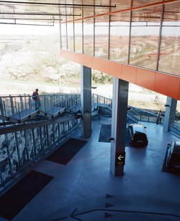 As there's no lobby, the building is always entered through the garage. If residents arrive by foot or bicycle, they can ascend the Mountain Dwellings by walking up a set of metal stairs that climb from south to north over the parking lot.