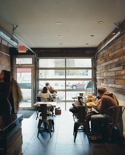 Hoagies' Heroes - Photo 9 of 13 - The roll-up doors on the facade give Taylor Gourmet an outdoor feel while the wooden walls made of recycled shipping pallets offer a textured, rustic feel.