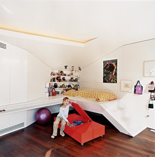 The Penthouse Has Landed - Photo 6 of 16 - Nora, the architects' six-year-old daughter, hangs out next to her built-in bed.