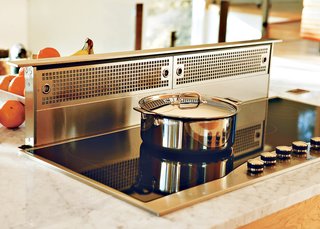 Because the kitchen is so open, Erik designed it in such a way that there’s room for everything from cookbooks to wine racks. Even the Viking stove hood disappears into the counter at the touch of a button. "People ask if we spend a lot of time cleaning, but that’s just not the case. There’s a place for everything."