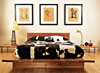 Graphic cowhides on the guest bed, the dining chairs, and the living room floor unite the varying levels of the house. That design element—and the cute oil derrick lamp in the guest bedroom—remind you that, yes, you are in Texas. The drawings are by Erik’s brother Jair, an architect working in New York.