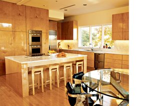 The distinctive cowhide-and-chrome dining chairs were designed and built by Raul 30 years ago. Erik and his brother Alan, a recent graduate of the University of Texas at Austin School of Architecture, de-signed the glass table. "The form for it came from prefab concrete ties," says Erik. "Everything in here fits together surprisingly well."