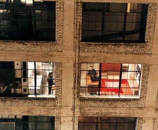 The mini-loft concept was simple enough: The space had to function as a traditional loft—high ceilings, open floor plan, large windows, and the sense of expansiveness offered by much larger lofts. Seems reasonable until you remember they had to squeeze a fully functioning kitchen, dining area, living room, bedroom, and bathroom, complete with bathtub, into just 500 square feet.