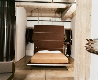 With a push of the sliding door, the bedroom morphs into an extension of the living room, adding much-appreciated square feet during dinner parties and other gatherings. The platform bed and backrest are both Tag Front designs.