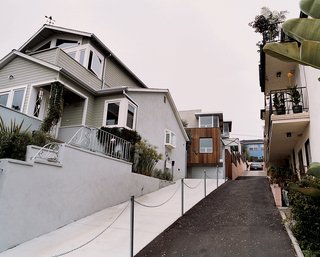 The restored original and new addition. After a brief tussle over access to their shared driveway (resulting in what Bornstein calls a "spite fence"), most of the occupants in the apartment building next door appreciate having a family as neighbors, rather than another big box to block their light and views.