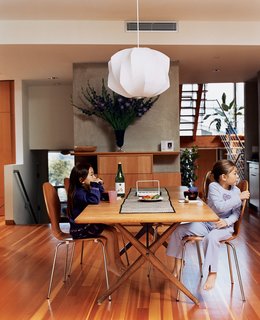 Kalia and Olivia in the dining room (the Danish dining table was acquired by Jesse’s parents in the mid-’70s, the dining chairs are by Arne Jacobsen, and the light fixture is by George Nelson).